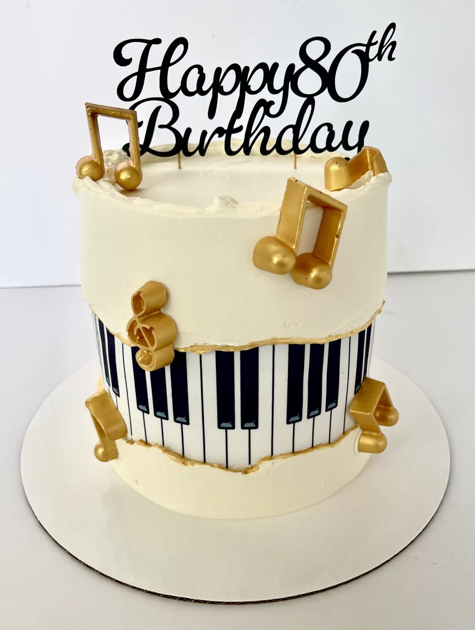80th White and gold music cake